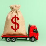 Red toy truck hauling a bag of money | Bailey Truck & Trailer